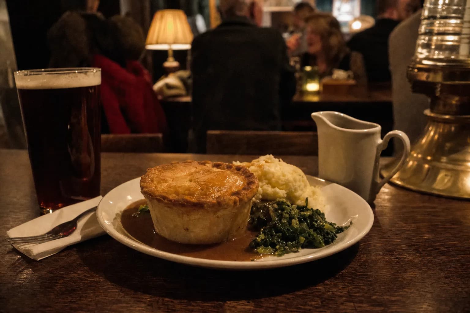 A steak and ale pie with mash, greens and gravy by lamplight (AI example photo)