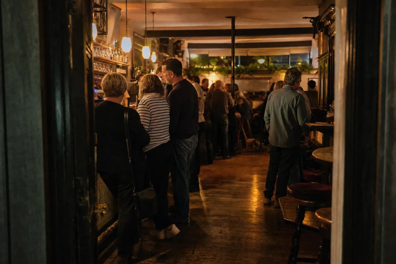 An example shot for the shot list: the pub bar at night, busy, from the doorway (AI example photo)